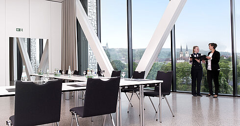 Conference room 11 Modern meeting room at Maritim Hotel Würzburg with large window, view and two people talking