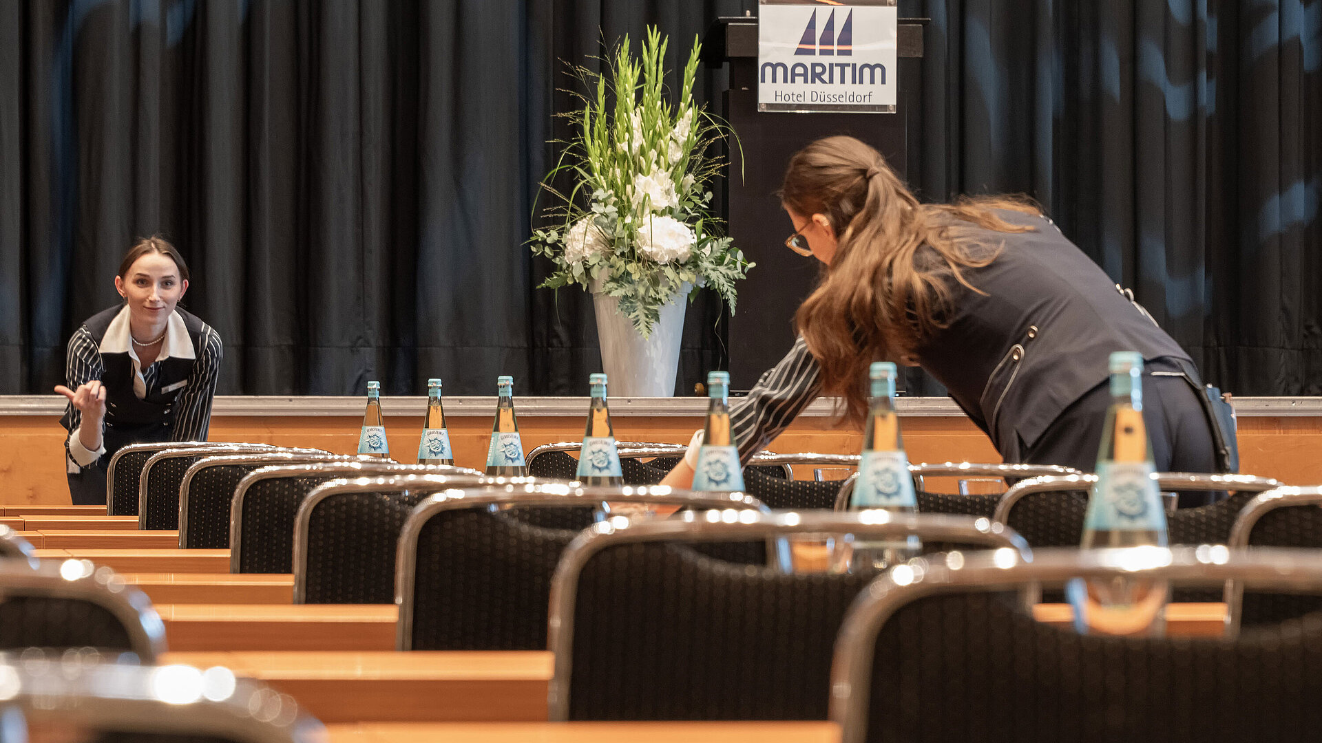 Conference services Staff prepare conference room with stage at Maritim Hotel Düsseldorf
