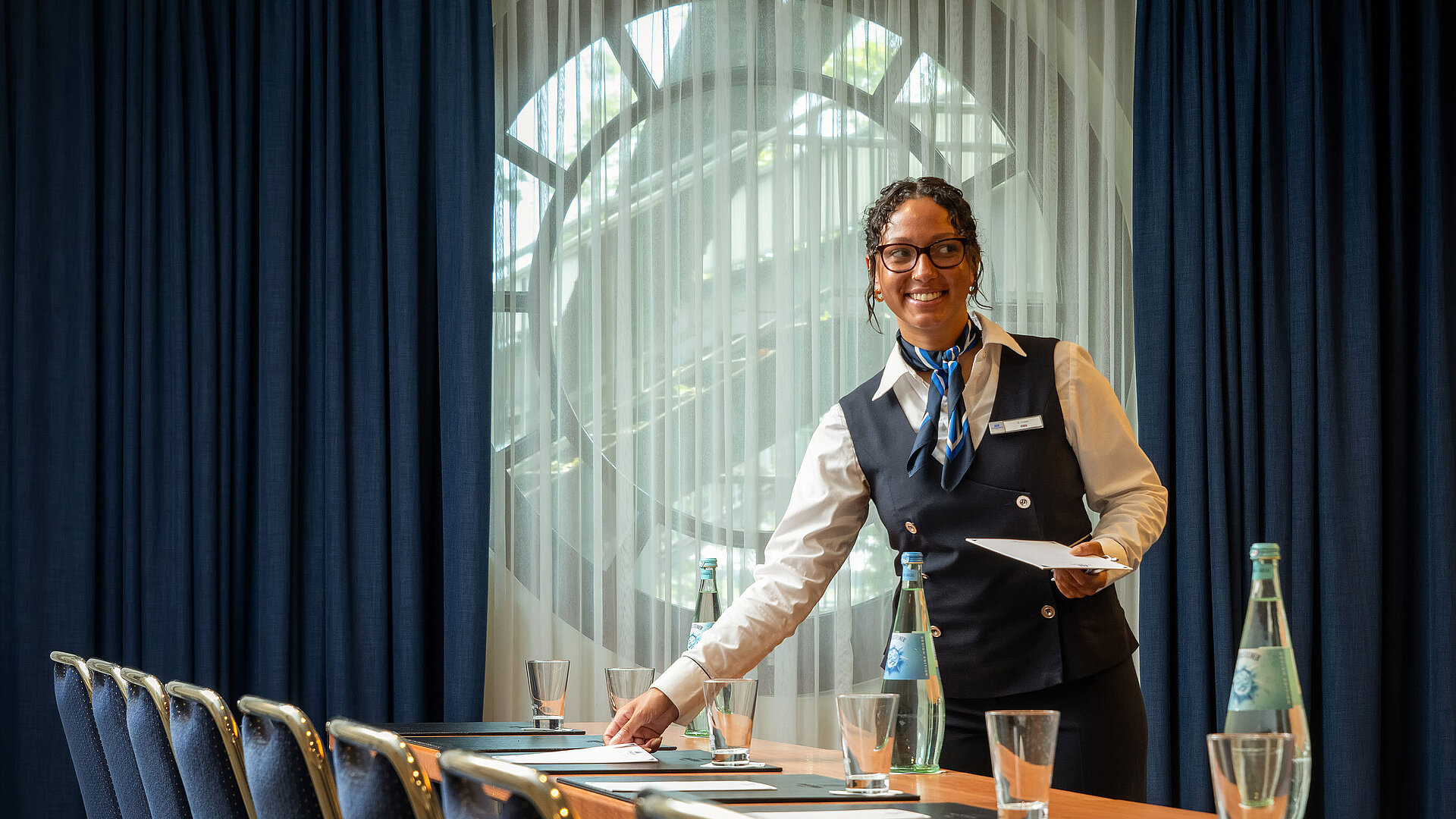 Conference service Staff member at Maritim Hotel Köln preparing conference room with drinks and documents