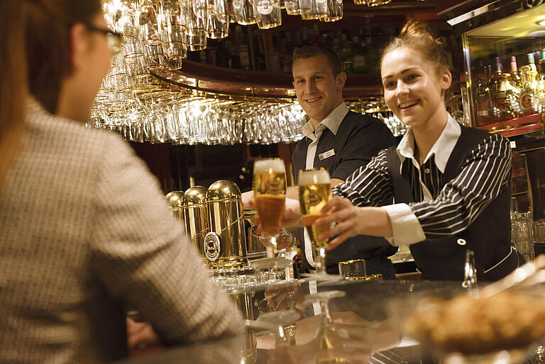Piano bar Two staff members serve freshly tapped drinks at the bar at the Maritim Hotel Ulm