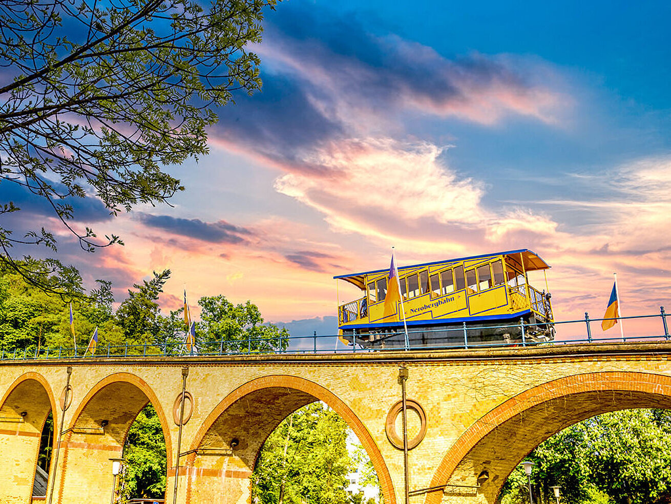 © Sina Ettmer - AdobeStock.com Historic Nerobergbahn funicular crossing bridge to Neroberg in Wiesbaden at sunset