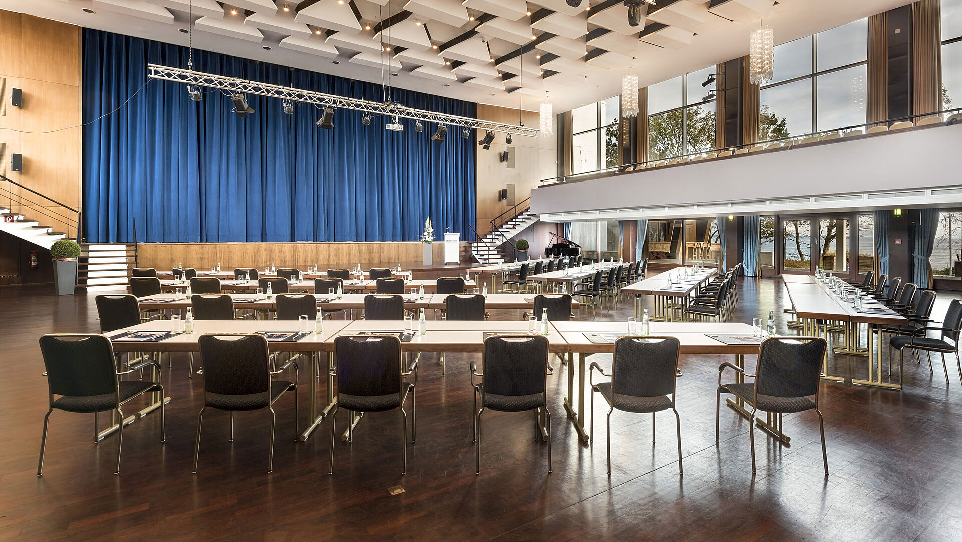 Saal Maritim Grand Hall "Maritim" at Maritim Seehotel Timmendorfer Strand with stage, blue curtains, and conference seating.
