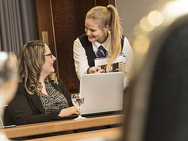 Maritim Conference Service A Maritim Hotel Bonn employee assists a participant during a meeting in Salon Rheinaue.