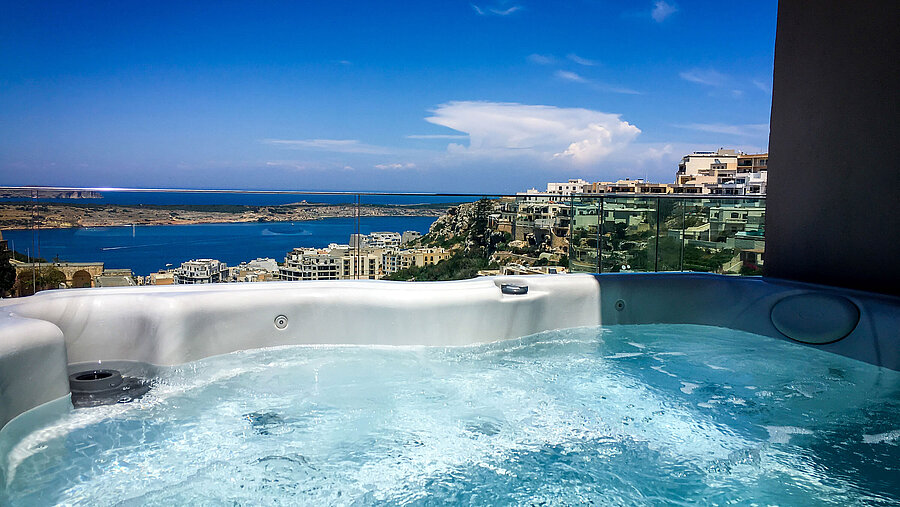 Hot tub with sea view Outdoor hot tub with stunning views of the sea and coastline