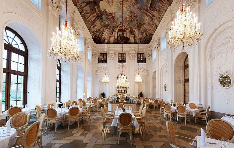 Apollo Saal Restaurant Elegant Apollo Hall at Maritim Hotel Fulda with chandeliers, fresco ceiling, and stylishly set tables.