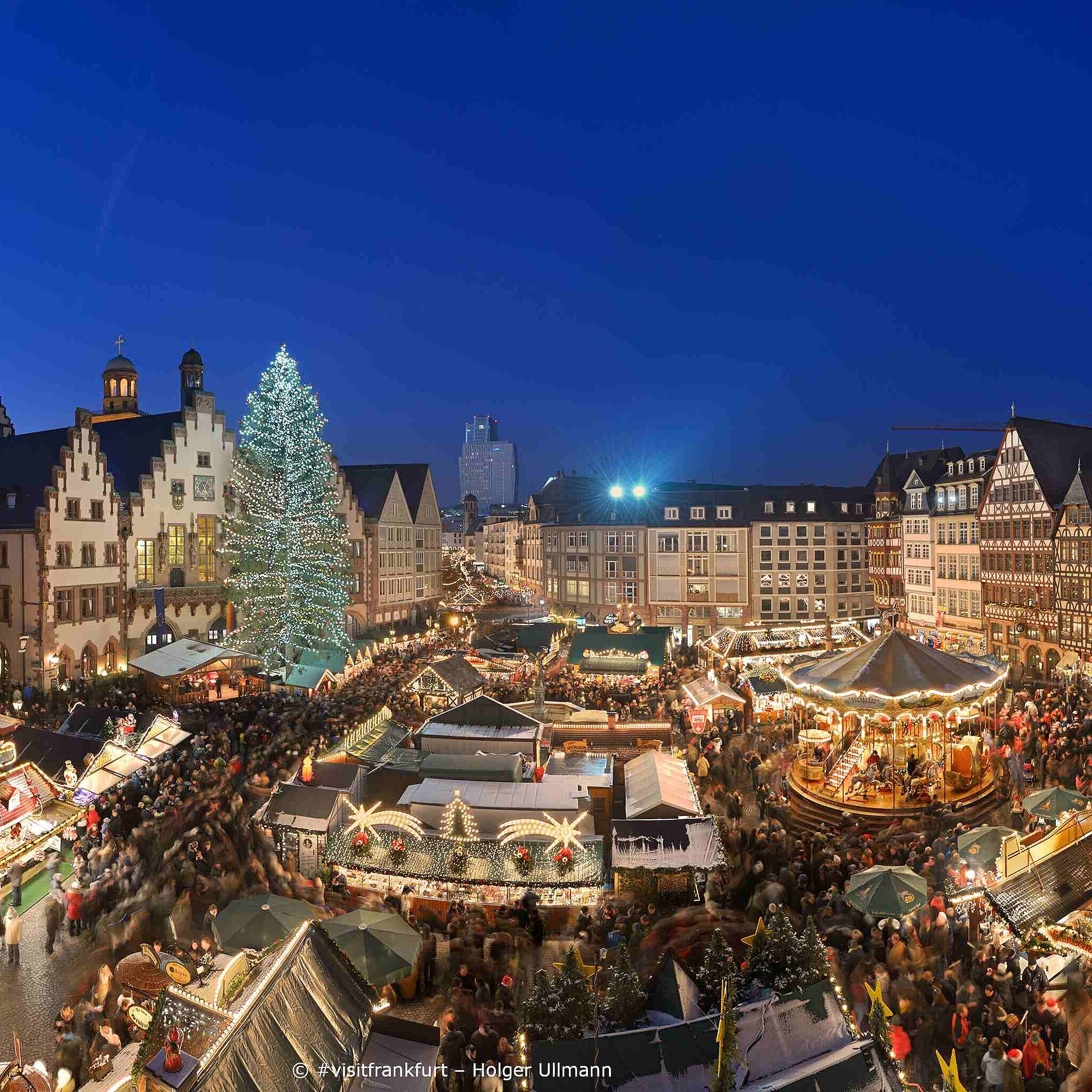 Frankfurt Christmas market at Römerberg Christmas market on Römerberg square in Frankfurt with illuminated tree and historic half-timbered houses