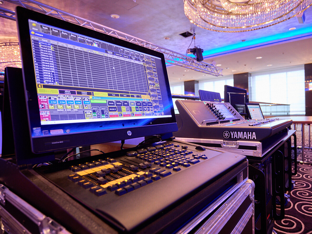 Modern event technology in a conference room Professional lighting and mixing console in a modern event space with stage setup.