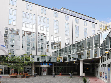 Exterior view Modern façade with glass details and courtyard of Maritim Hotel Munich