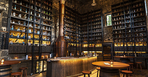 "The Distillery" Stylish bar with copper still, extensive spirits selection and natural stone walls