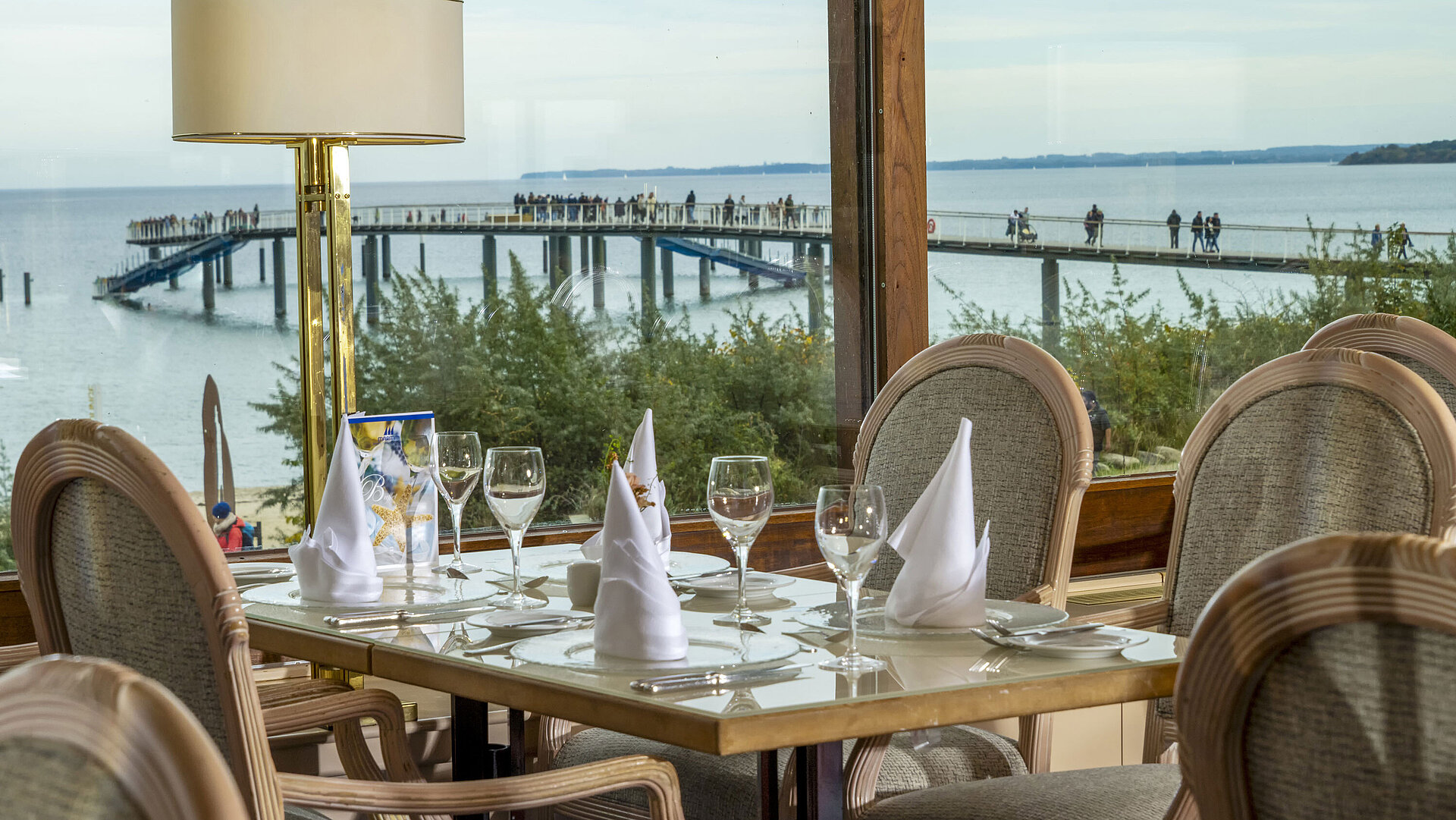Restaurant with Baltic Sea view Elegant restaurant table with a view of the Baltic Sea and pier, Maritim Hotel Timmendorfer Strand.