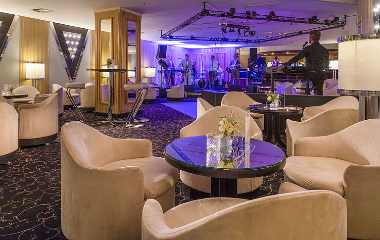 73Bar Elegant bar area with live band, atmospheric lighting and comfortable seating for guests.