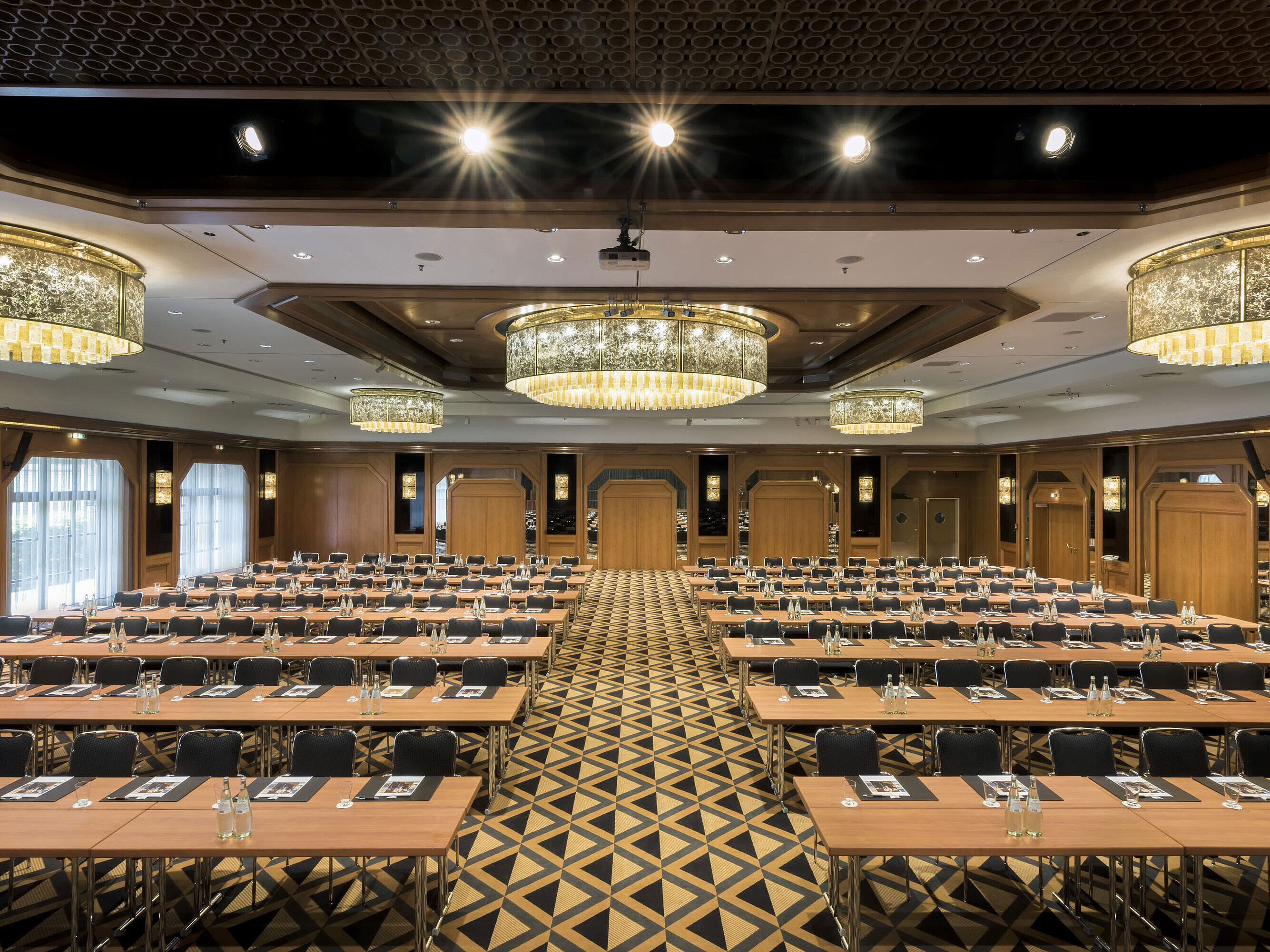 Saal Maritim classroom style Elegant conference hall with stage, chandeliers, and modern seating at Maritim Hotel Königswinter.