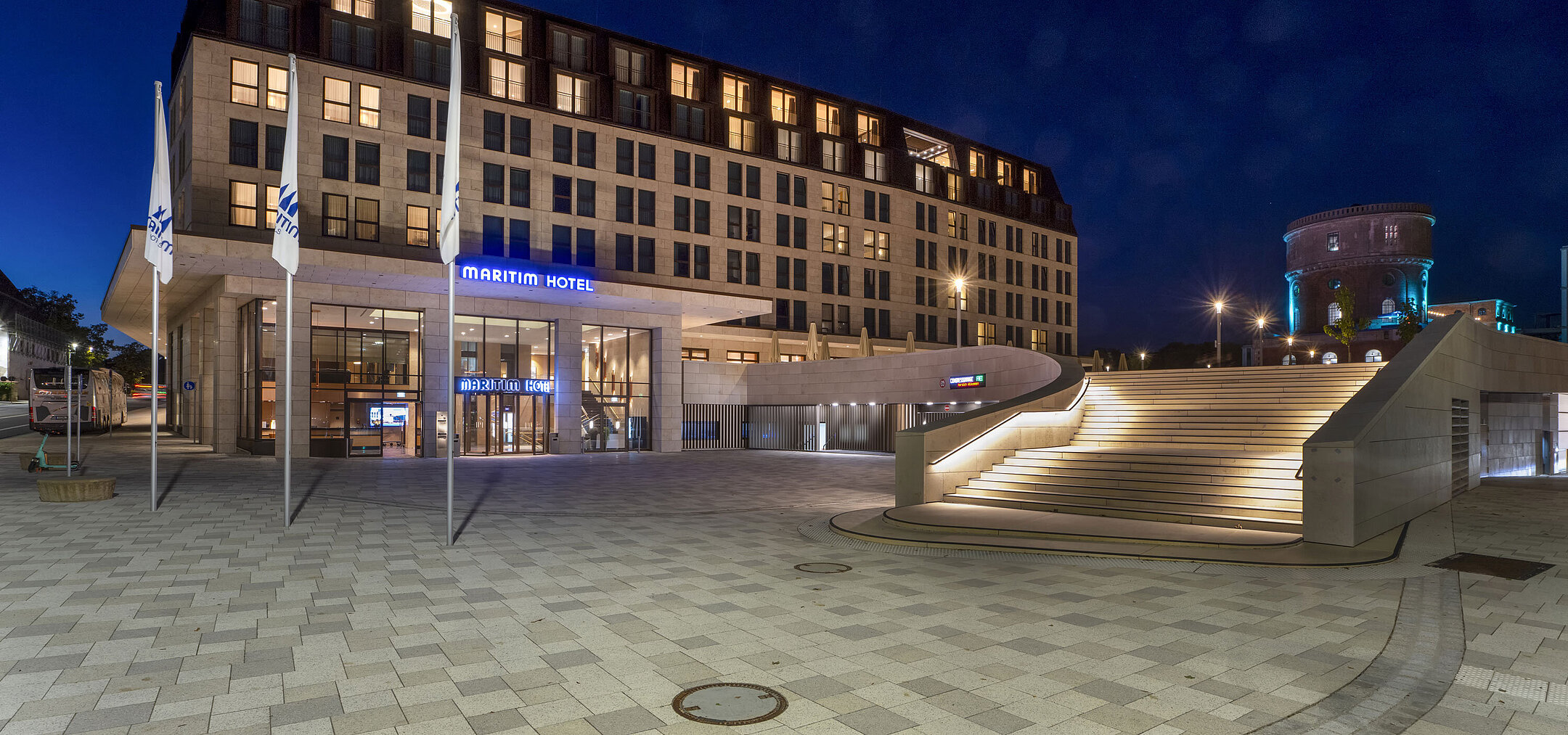 Exterior view Entrance area of Maritim Hotel Ingolstadt at night with atmospheric lighting and staircase.