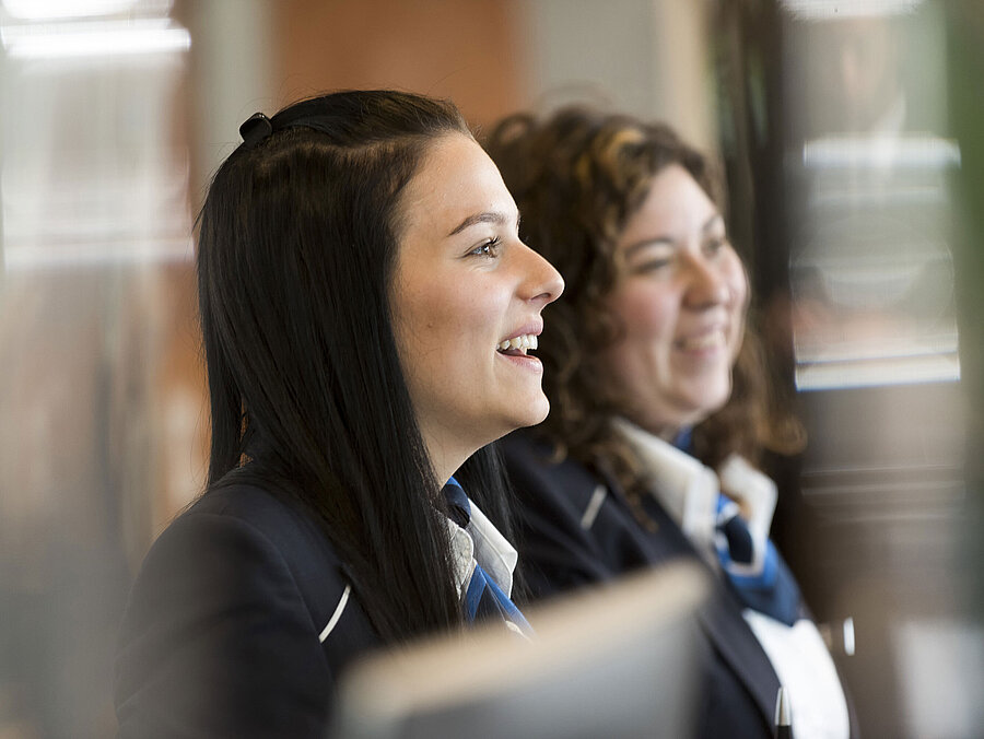 Employee Smiling reception staff at Maritim Hotel Frankfurt welcoming guests.