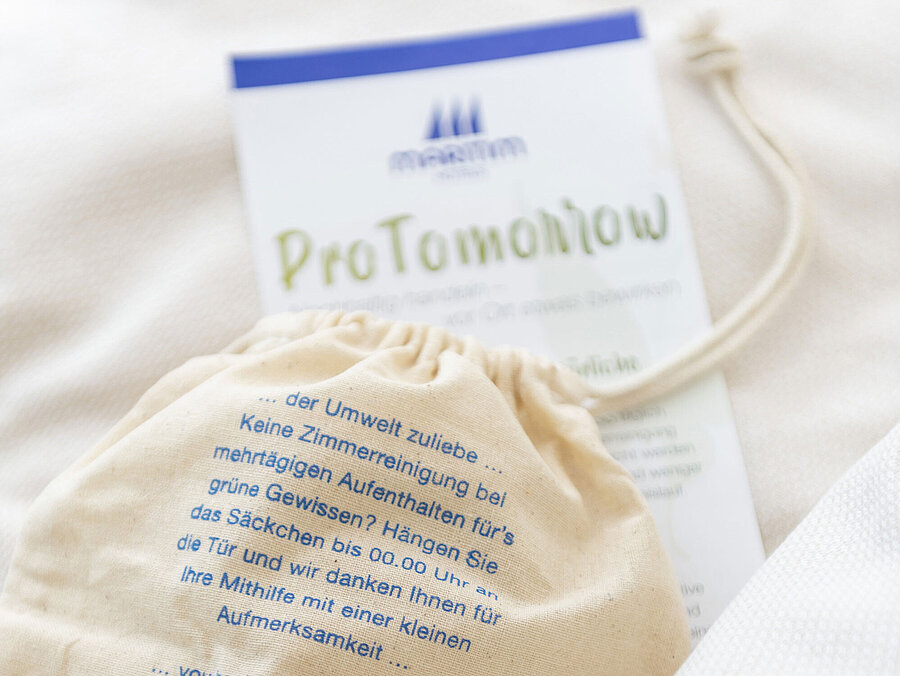 ProTomorrow Maritim Hotels cotton bag promoting eco-friendly room cleaning and sustainable guest choices.