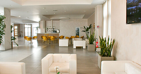 Lobby Bright lobby of Maritim Resort Calabria with white armchairs and yellow chairs