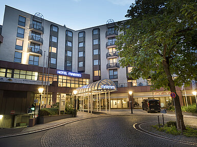 Exterior view at night Atmospheric hotel entrance of Maritim Hotel Bad Homburg at dusk with lighting.