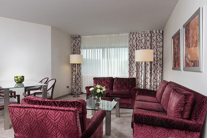 Family Suite Bright and spacious family suite at the Maritim Hotel Bonn with modern furniture and cozy seating area.