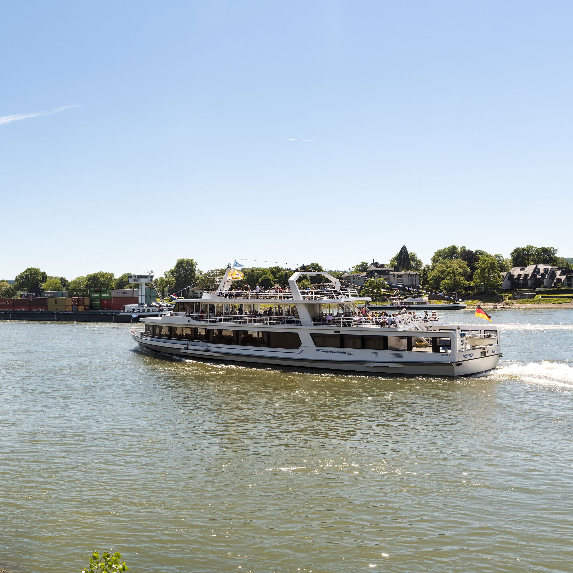 Boat trip on the Rhine A sightseeing ship on the Rhine near Königswinter with a view of the picturesque landscape.